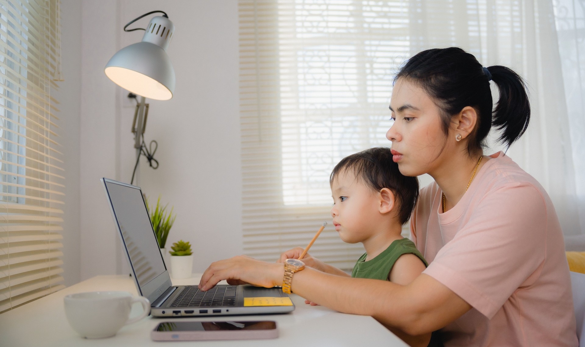 Mother working from home with child