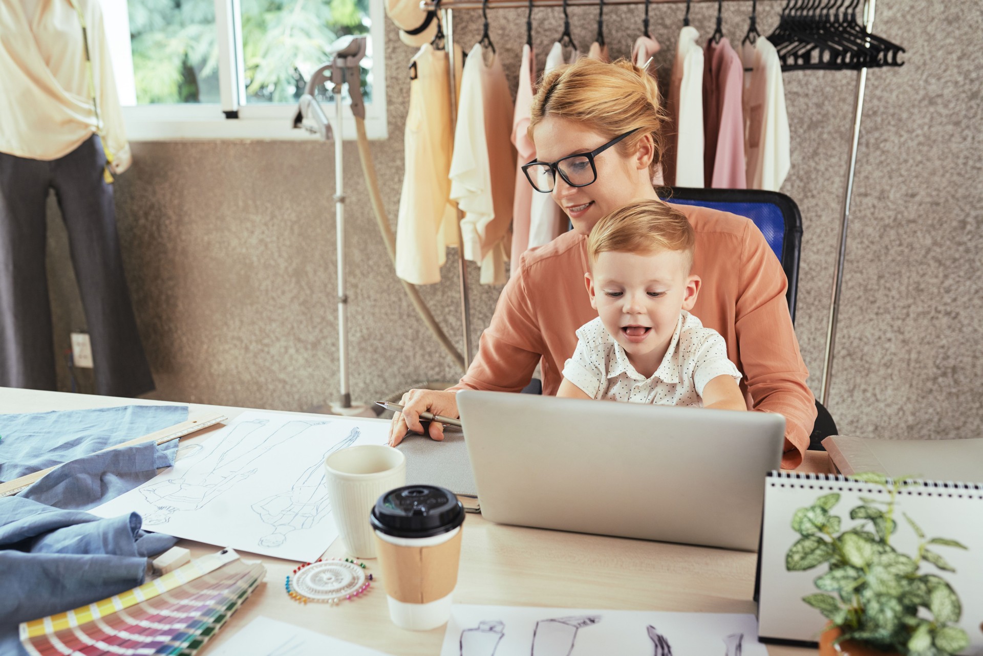 Fashion designer with kid working