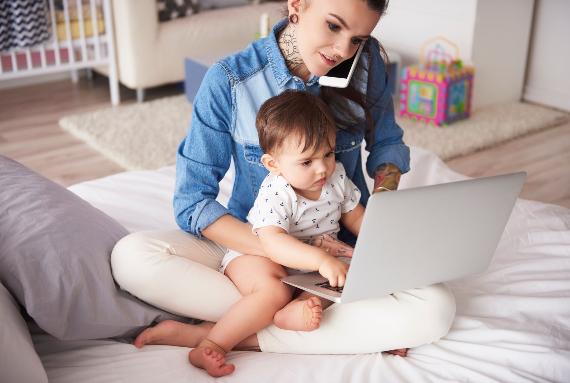 Young mother working from home with son